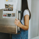 girl picking something from the fridge