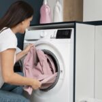 woman taking clothes from the washing machine