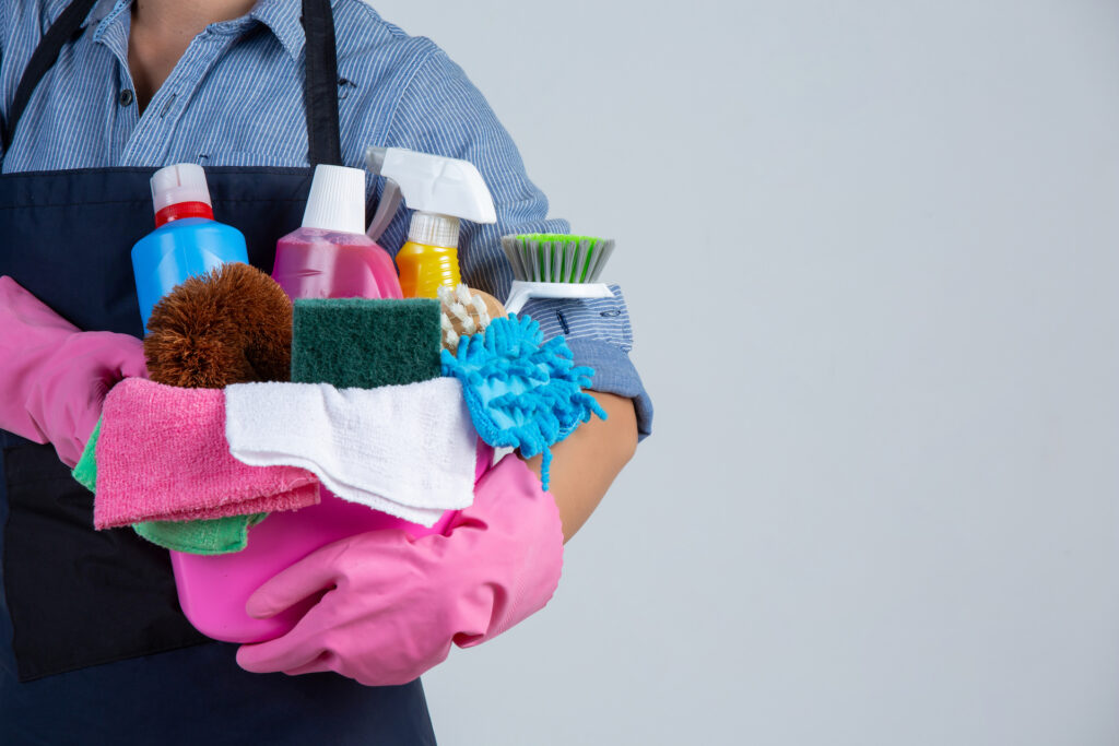 woman holding cleaning materials