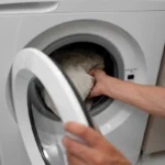 loading clothes on the washing machine